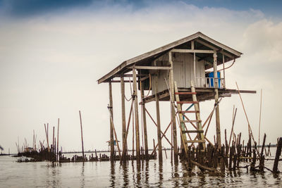 Lifeguard hut in sea against sky