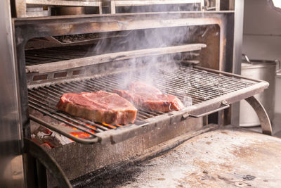 High angle view of meat on barbecue grill