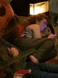 Young woman sitting on sofa at home