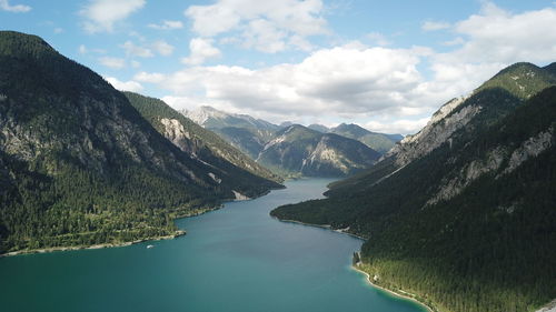 Scenic view of lake amidst mountains against sky