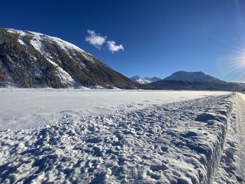 Scenic view of snowcapped mountains against blue sky