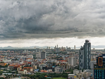 Cityscape against cloudy sky