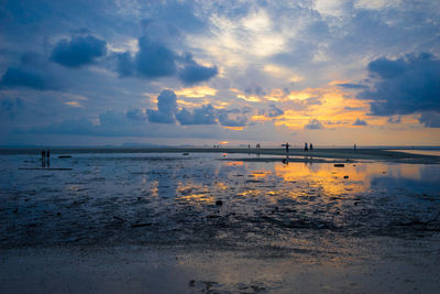 Scenic view of sea against cloudy sky