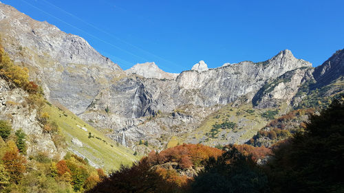 Scenic view of rocky mountains against clear blue sky