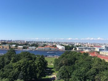 High angle view of buildings against clear blue sky