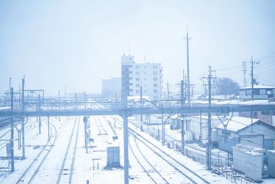 High angle view of snow covered railroad tracks in city