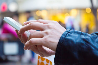 Close-up of woman holding smart phone