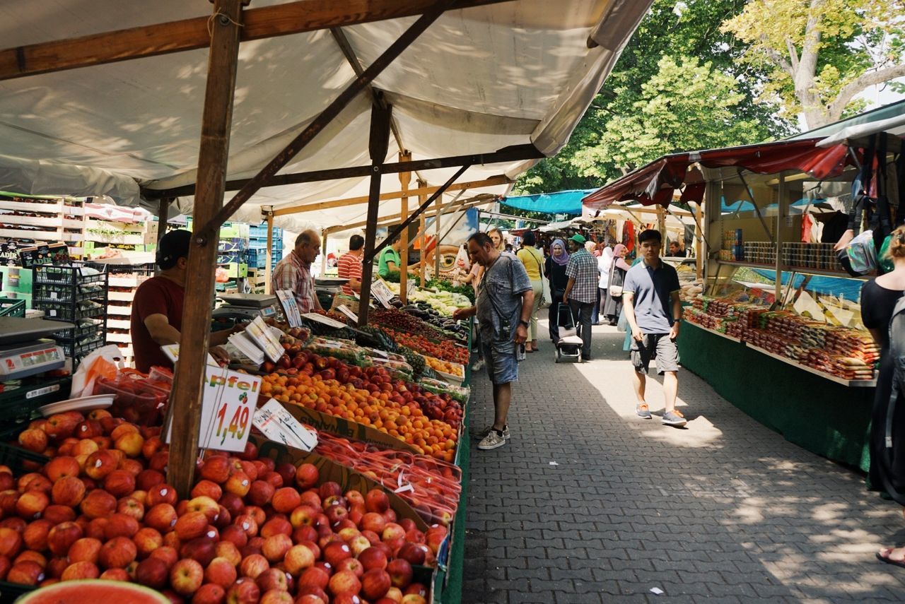 PEOPLE AT MARKET STALL