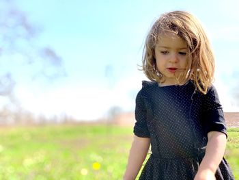 Cute girl standing on field