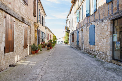 Footpath amidst buildings in city