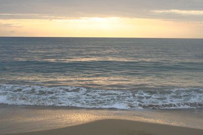 Scenic view of beach at sunset