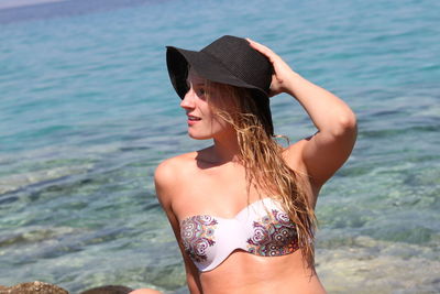 Beautiful woman wearing bikini top at beach