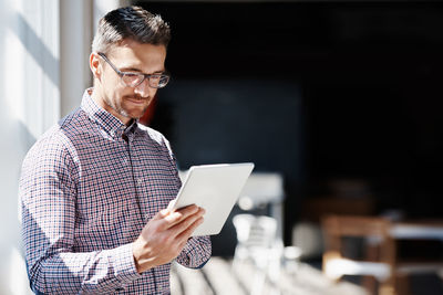 Businessman looking at digital tablet at office