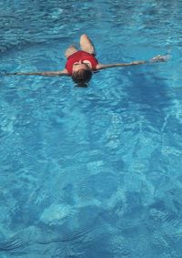 High angle view of boy swimming in pool