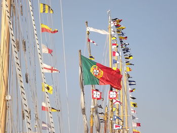 Low angle view of portuguese flag on mast against sky