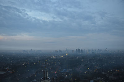 High angle view of buildings against cloudy sky