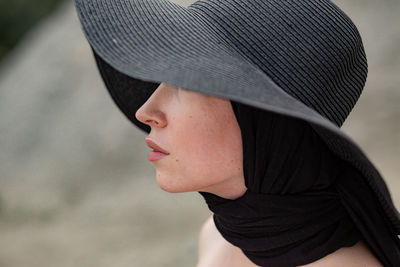 Close-up of woman wearing black hat