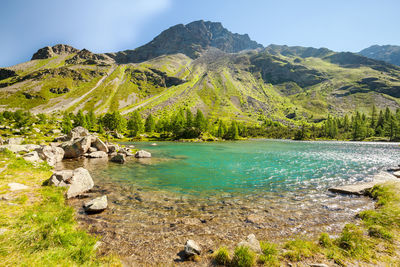 Scenic view of rocks and mountains against sky