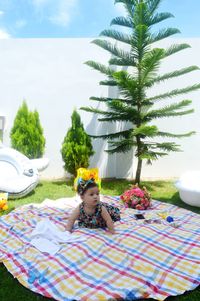 Portrait of a baby girl sitting on a picnic blanket 