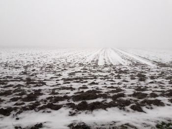 Snow covered landscape against sky