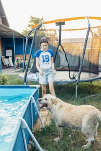 Rear view of man with dog in boat