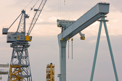 Low angle view of crane against sky