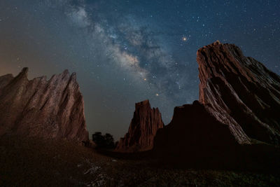 Panoramic view of rocks against sky at night