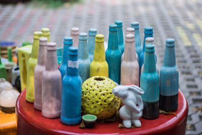 Close-up of multi colored bottles on table at market stall