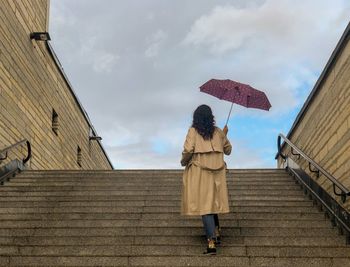 Rear view of woman standing against sky