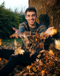 Portrait of smiling young man during autumn