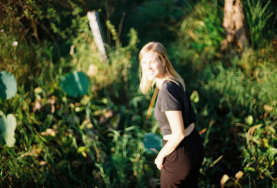 Side view of a young woman standing on land
