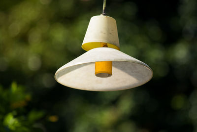 Close-up of yellow bell hanging on rope