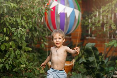 Portrait of happy boy standing outdoors