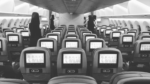 Air stewardess standing in airplane