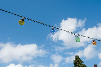 Low angle view of flags hanging against sky