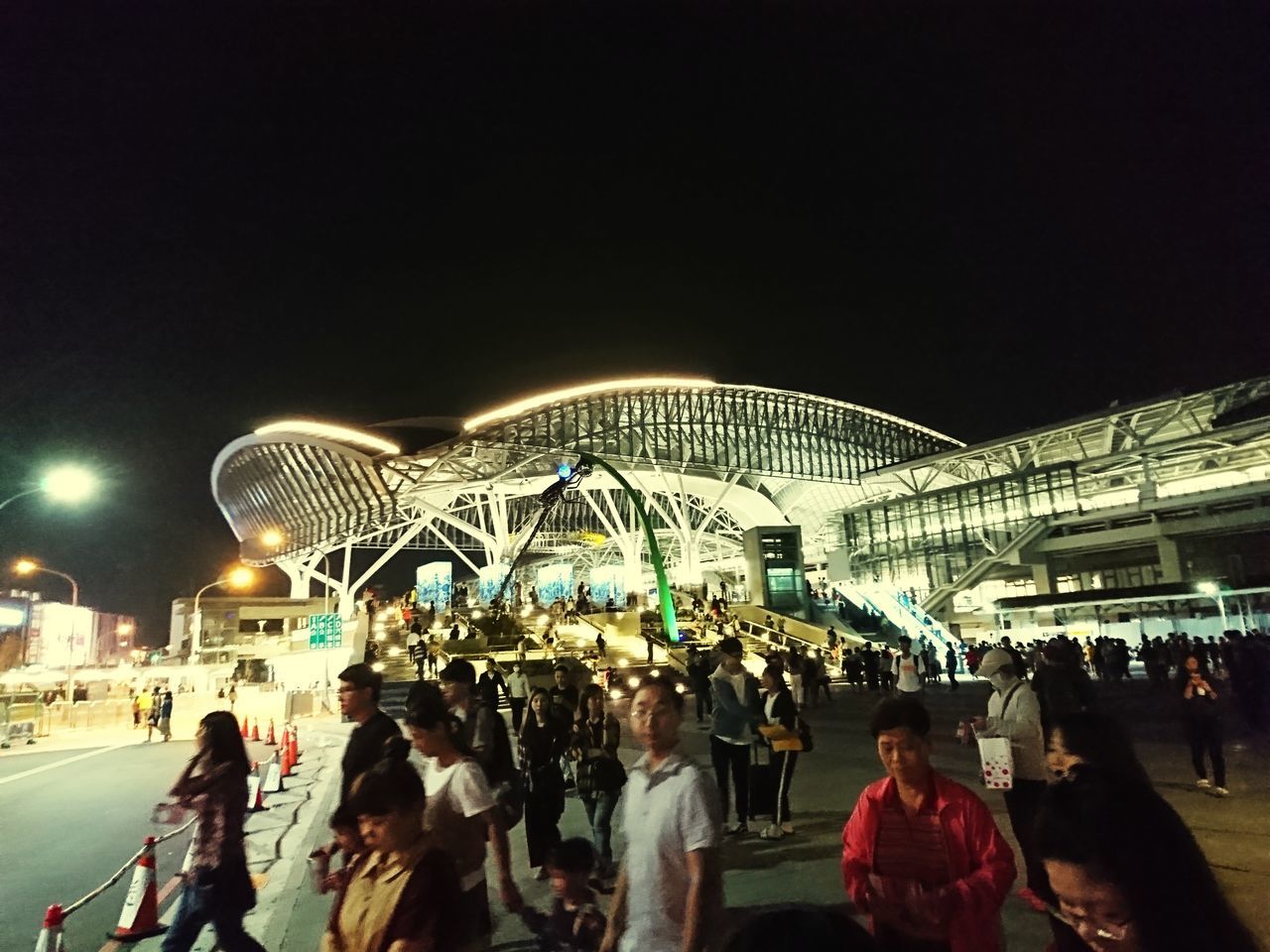 GROUP OF PEOPLE IN ILLUMINATED BUILDING AT NIGHT