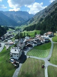Aerial view of buildings in city against sky