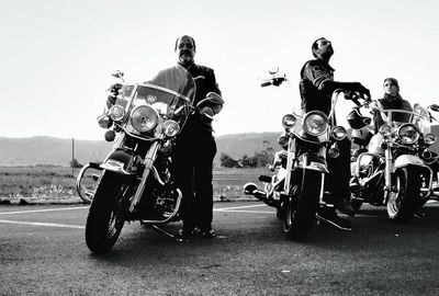 Man standing on motorcycle