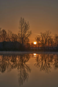 Scenic view of lake against sky during sunset