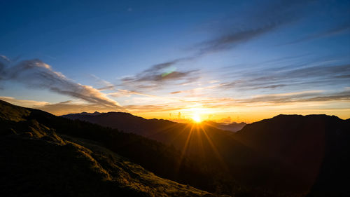 Scenic view of mountains against sky during sunset