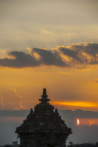 Silhouette temple against sky during sunset