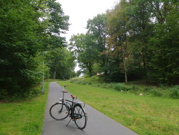 Bicycle on road against sky