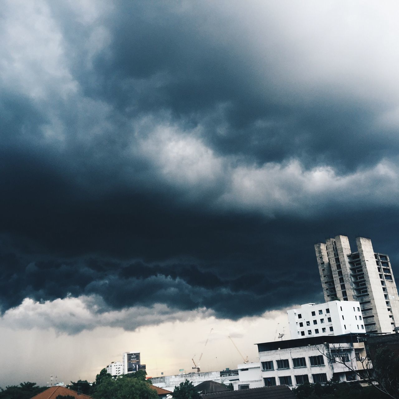 building exterior, architecture, built structure, sky, cloud - sky, cloudy, weather, overcast, low angle view, city, storm cloud, building, cloud, residential building, residential structure, day, outdoors, house, cloudscape, no people