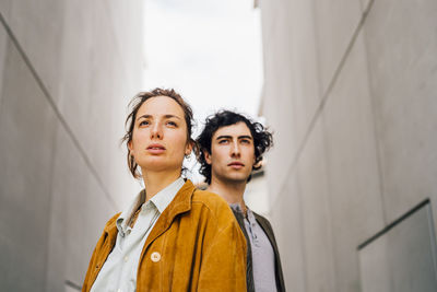 Couple wearing jackets looking away