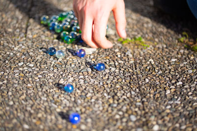 Low section of person on pebbles