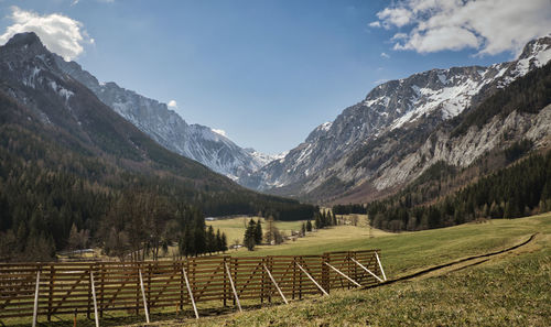 Scenic view of field and mountains against sky