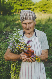 Portrait of senior man holding religious cross