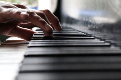 Close-up of man playing piano