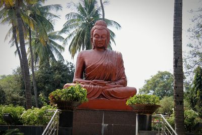 Low angle view of statue against trees