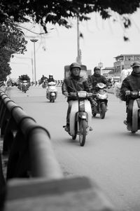 People riding motorcycle on road
